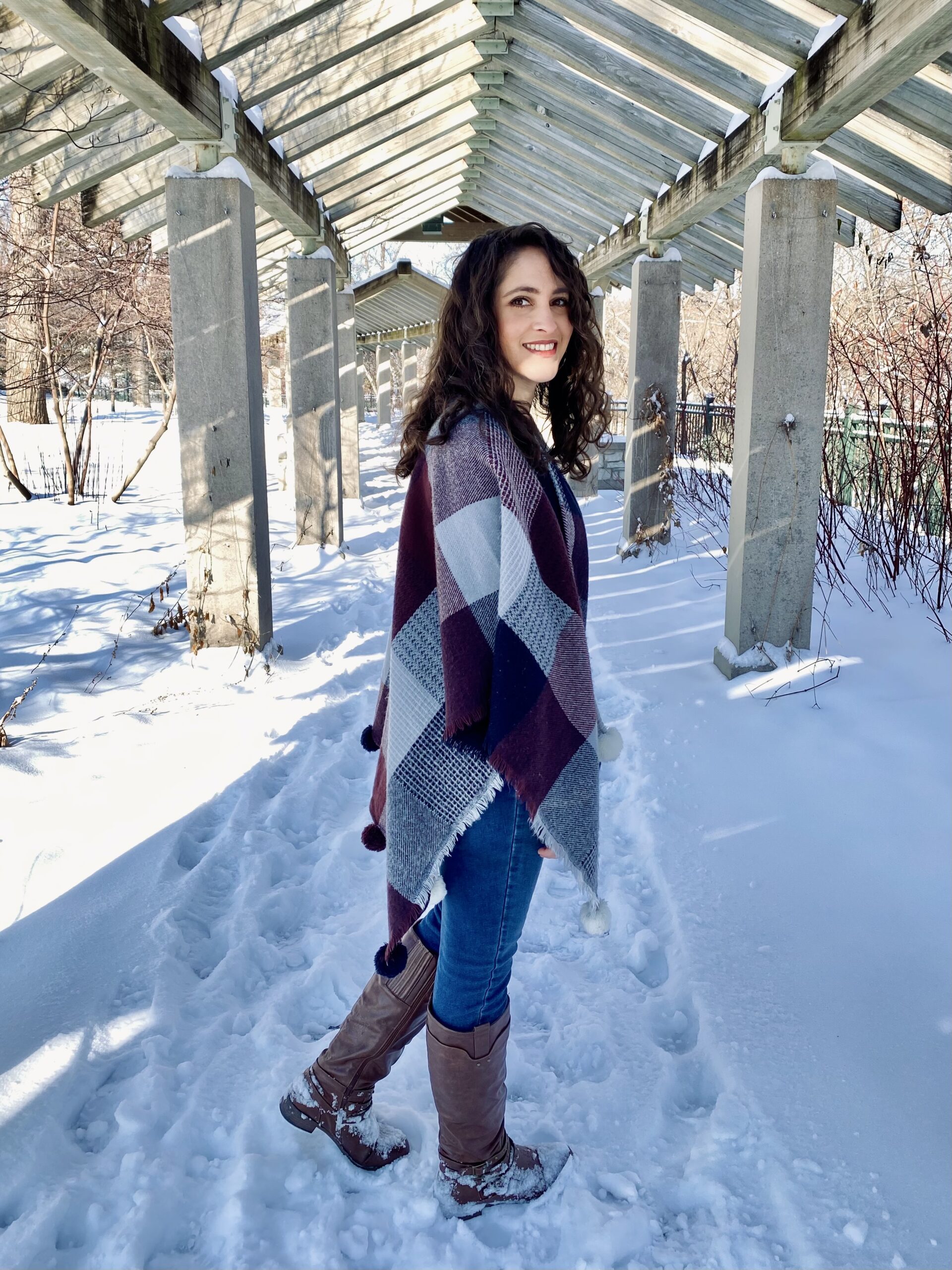 Ellen with a shawl out in the snow looking back at the camera.